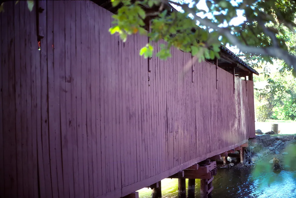 Historical 1981 photograph of the covered bridge over the water at Fowler Park